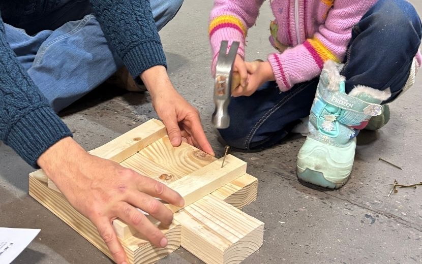 Tool Demo father helping daughter hammer
