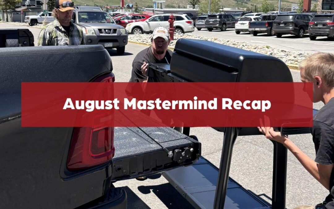 Hardware store employees load a large grill into a customer’s pickup truck with the text “August Mastermind Recap.”