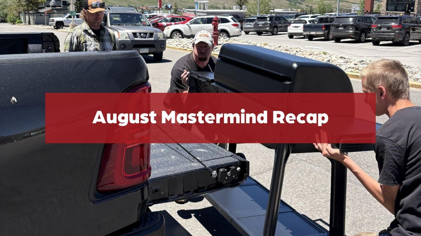 Hardware store employees load a large grill into a customer’s pickup truck with the text “August Mastermind Recap.”